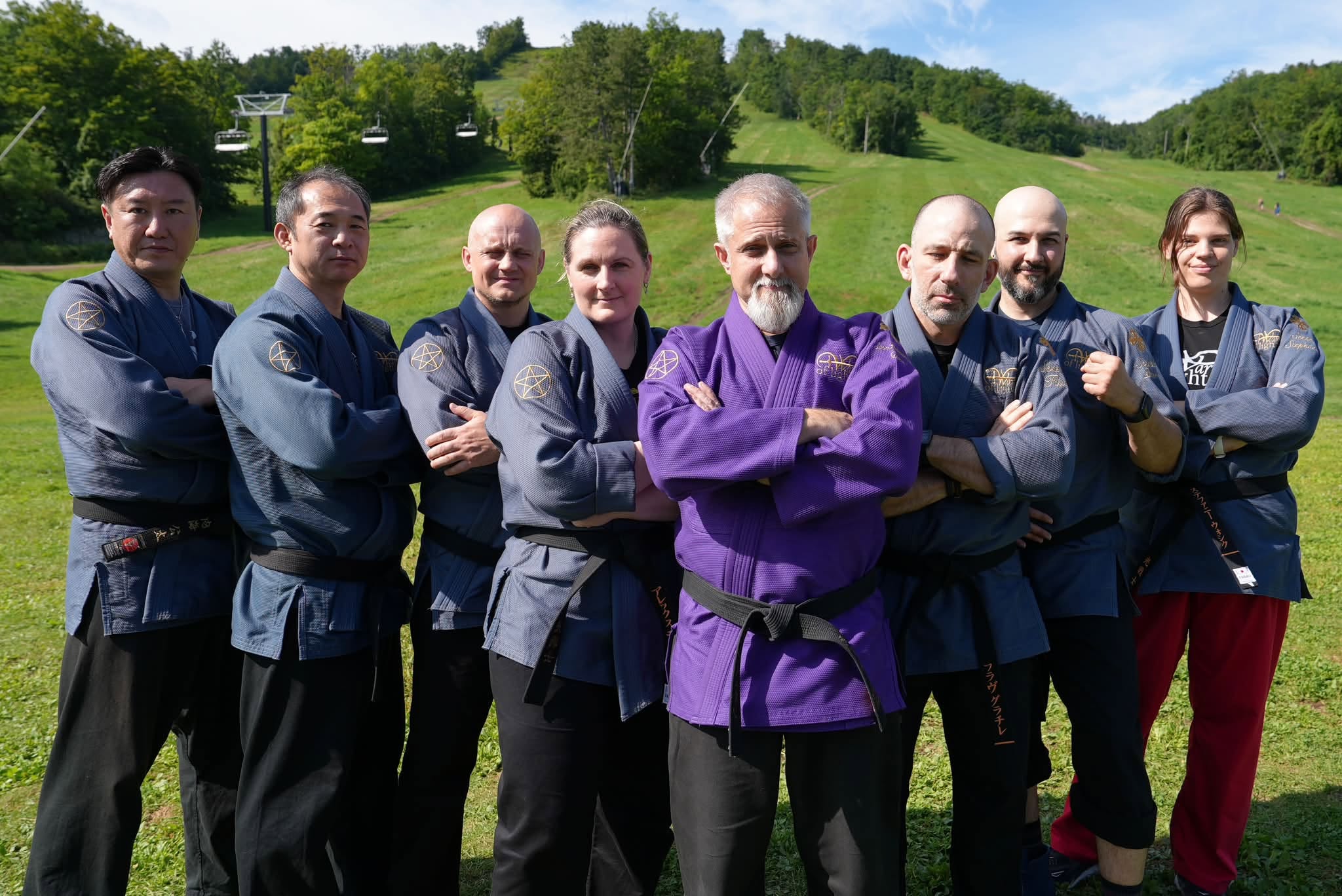 A group of Modern Mystery School teachers and Ritual Masters, arms crossed