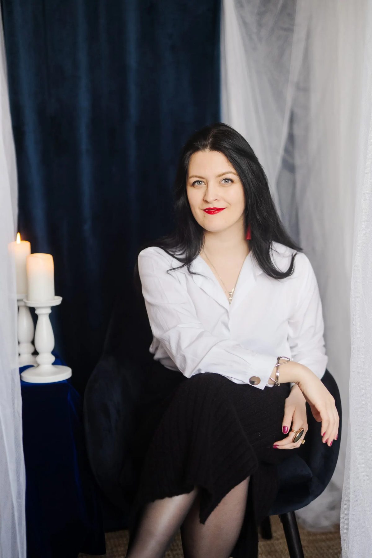 Diana Coman beside candlelight